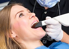 Woman getting digital dental impression of her smile